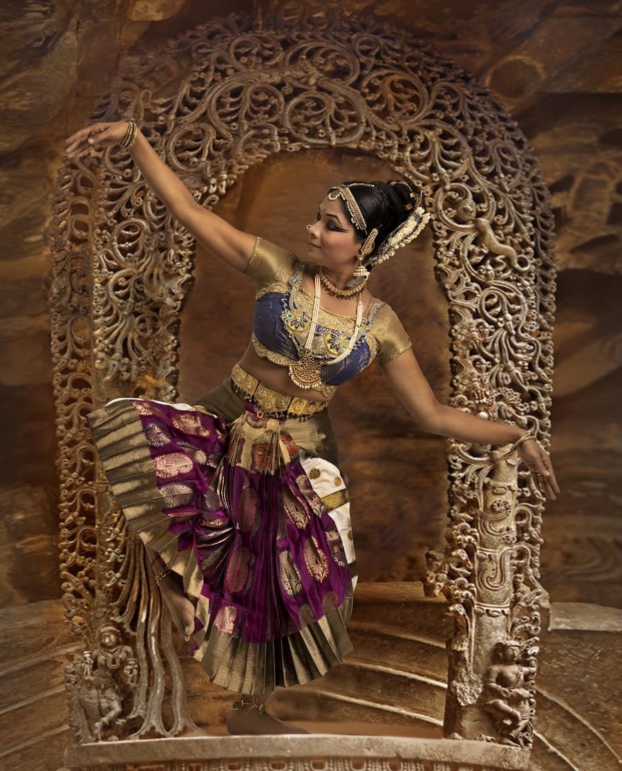 Shobana mid-movement under stage light